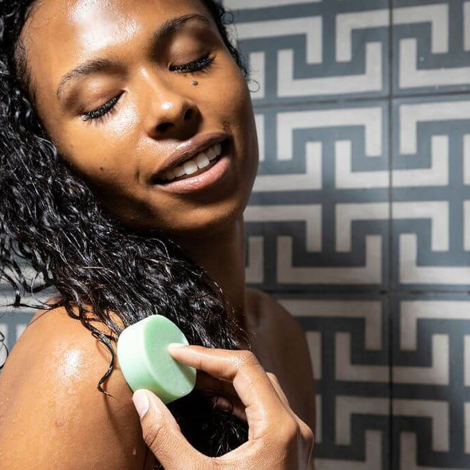 Woman using cocolime conditioner bar